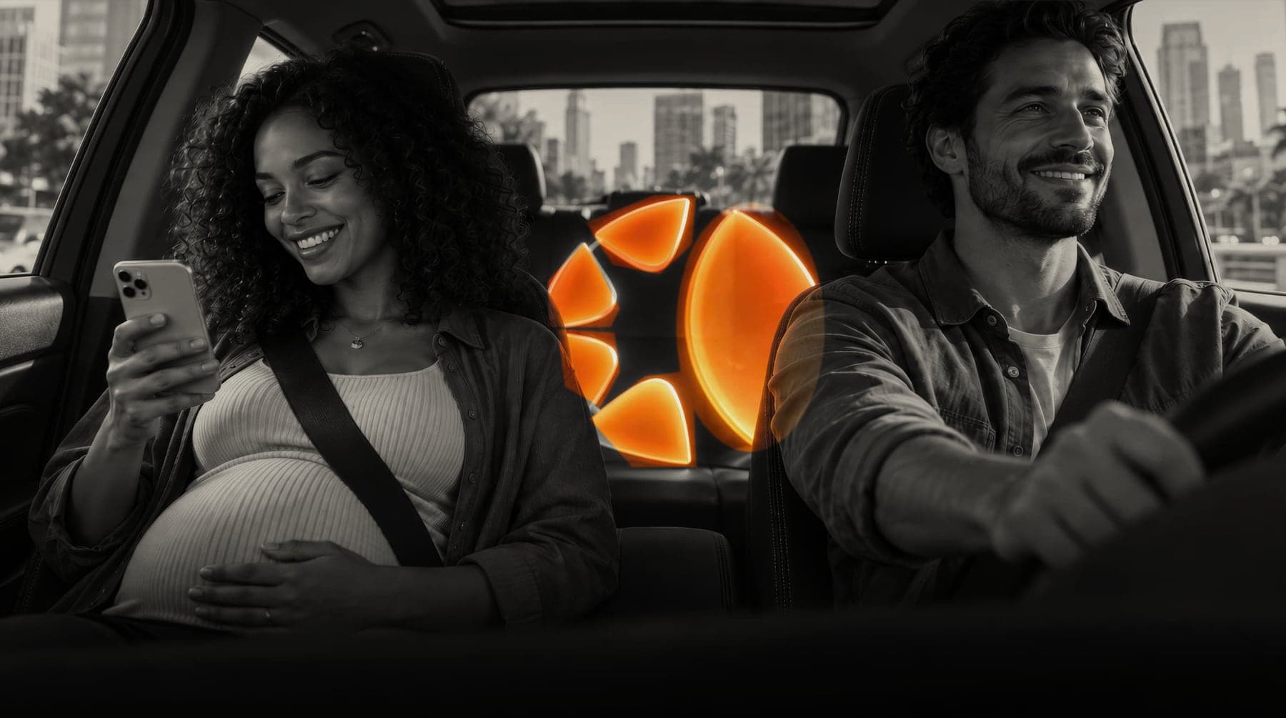 A couple driving through the city with the Legacy AI logo glowing between the seats